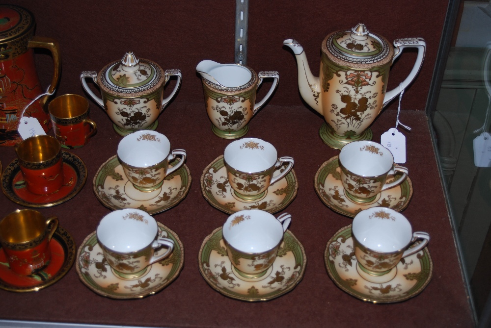 NORITAKE IVORY GROUND COFFEE SET WITH GILDED FLORAL DETAIL.