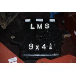 RAILWAYANA - A VINTAGE CAST IRON LMS (LONDON MIDLANDS SCOTLAND) AXIL BOX COVER WITH BLACK AND