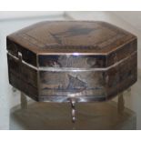 A MID-20TH CENTURY IRAQI SILVER AND NIELLO TRINKET BOX, OF HEXAGONAL FORM ON THREE SHORT LEGS, THE