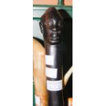 EBONISED TRIBAL WALKING STICK WITH MALE HEAD CARVED DETAIL.