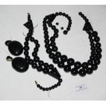 A COLLECTION OF VICTORIAN JET MOURNING JEWELLERY, INCLUDING TWO JET BEAD DOUBLE STRAND NECKLACES,