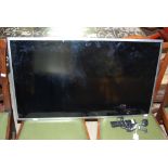 MODERN SAMSUNG WALL MOUNTED TV, TOGETHER WITH CABLE AND REMOTE, 92CM LONG.