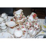 A 20TH CENTURY FLORAL TEA SET BY 'NEW CHELSEA', STAFFORDSHIRE, DECORATED WITH ROSES, TOGETHER WITH
