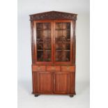 A 19TH CENTURY CHINESE CARVED DARKWOOD BOOKCASE, THE POINTED PEDIMENT CARVED IN RELIEF WITH