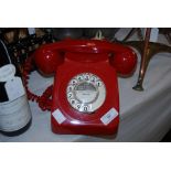 A 20TH CENTURY ROTARY DIAL RED TELEPHONE MARKED FOR ABERDEEN 861519, WITH ORIGINAL CREAM CABLE