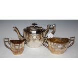 THREE PIECE EPBM TEA SET, OVAL SHAPED WITH PART-GADROONED DETAIL.