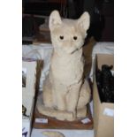 MID - LATE 20TH CENTURY UNGLAZED CERAMIC FIGURE OF A SEATED CAT ON WOODEN PLINTH BASE.