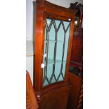 REPRODUCTION CONCAVE CORNER CUPBOARD WITH GLAZED CUPBOARD DOOR OVER SOLID CUPBOARD DOOR BELOW.