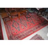 A 20TH CENTURY ROYAL KESHAN SOUMAC CARPET WITH LABEL TO BACK, IN DARK RED GROUND WITH REPEATING