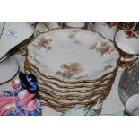 SET OF EIGHT FRENCH LIMOGES STYLE FLORAL DESSERT PLATES WITH FLUTED GILT RIMS, EACH 24CM DIAMETER.