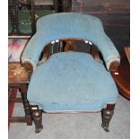 A LATE 19TH / EARLY 20TH CENTURY CARVED OAK UPHOLSTERED ARMCHAIR, THE TUB BACK ARM REST SUPPORTED ON