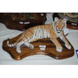 A SCOTTISH ART WILDTRACK PAINTED RESIN FIGURE OF A TIGER ON A WOODEN BASE, PAPER LABEL TO UNDERSIDE,