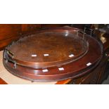 A 19TH CENTURY MAHOGANY OVERSIZED OVAL SHAPED TWIN-HANDLED SERVING TRAY TOGETHER WITH ANOTHER