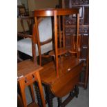 OAK DROP-LEAF TABLE WITH SIX BARLEY TWIST LEGS TOGETHER WITH A BLONDE MAHOGANY OVAL OCCASIONAL TABLE