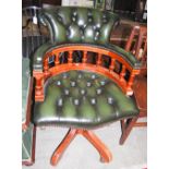 A LATE 20TH CENTURY GREEN LEATHERETTE UPHOLSTERED CAPTAINS CHAIR, THE BACK SUPPORT, ARMS AND SEAT