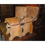 PAIR OF FOLDING CARVED WOODEN CHAIRS IN THE MANNER OF MISERICORD, THE FOLDING TOP UNDERSIDE CARVED