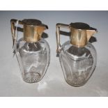 PAIR OF LATE VICTORIAN SILVER-MOUNTED CLEAR GLASS CLARET JUGS, MAKERS JOHN GRINSELL & SONS,