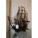 A CLOVE HANDMADE MODEL OF A THREE-MASTED GALLEON ON STAND.