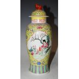 A CHINESE PORCELAIN YELLOW GROUND JAR AND COVER, DECORATED WITH PANELS OF FIGURES, EARLY 20TH