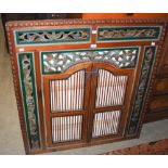 A 20TH CENTURY INDIAN CARVED WOODEN SCREEN WITH PAIR OF CENTRAL SHUTTERS, THE SHUTTERS WITH DOWEL