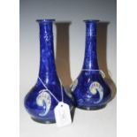 PAIR OF ROYAL DOULTON BLUE GROUND STONEWARE BOTTLE VASES IN THE ART NOUVEAU STYLE