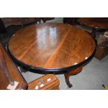 A 19TH CENTURY ROSEWOOD CIRCULAR CENTRE TABLE RAISED ON THREE SCROLL SUPPORTS, CENTRED BY A TURNED