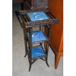 LATE 19TH CENTURY AESTHETIC EBONISED BAMBOO-EFFECT THREE-TIER JARDINIERE STAND WITH THREE MINTON