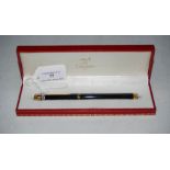 CARTIER, PARIS, A YELLOW METAL MOUNTED BLACK CASED INK PEN, NUMBERED 052 2998 IN ORIGINAL '