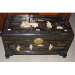 A 20TH CENTURY CHINESE MOTHER OF PEARL AND BONE INLAID BLACK LACQUER STYLE TRUNK, THE TOP AND