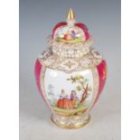 A DRESDEN PORCELAIN PUCE GROUND URN AND COVER DECORATED WITH PANELS OF FIGURES IN GARDENS DIVIDED BY