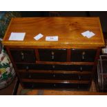 A 20TH CENTURY APPRENTICE/ MINIATURE CABINET FORMED OF THREE SHORT DRAWERS OVER THREE LONG