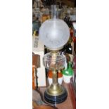 LATE 19TH CENTURY/ EARLY 20TH CENTURY BRASS OIL LAMP WITH CUT GLASS RESERVOIR AND A SPHERICAL ACID-