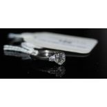 AN ART DECO WHITE METAL AND DIAMOND SOLITAIRE RING, THE SHOULDERS SET WITH BAGUETTE CUT DIAMONDS,
