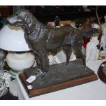 A MODERN BRONZED RESIN FIGURE OF A MOUNTAIN DOG ON A RECTANGULAR WOODEN PLINTH BASE, 54CM LONG