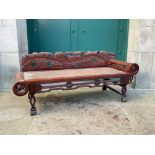 A 20TH CENTURY CHINESE CARVED DARK WOOD DAY BED, WITH CARVED AND PIERCED BACK RAIL IN THE FORM OF