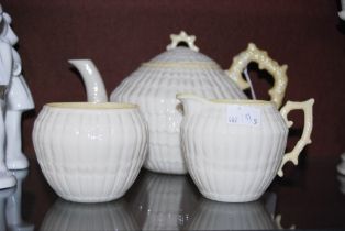 A BELLEEK PORCELAIN THREE-PIECE TEA SET COMPRISING TEAPOT AND COVER, SUGAR AND CREAM WITH LUSTRE