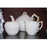 A BELLEEK PORCELAIN THREE-PIECE TEA SET COMPRISING TEAPOT AND COVER, SUGAR AND CREAM WITH LUSTRE