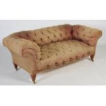 A late 19th / early 20th century chesterfield sofa, the back, arms and seat with buttoned upholstery