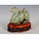 A 19th century Chinese green jade carving of a recumbent Bactrian camel, Qing Dynasty, mounted on