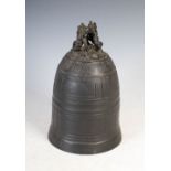 A Chinese bronze bell, of typical form with raised line panels to the body, the top with an