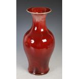 A 20th century Chinese sang de boeuf flambe glazed porcelain vase, of baluster form with flared