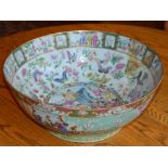 A Chinese porcelain famille rose Canton punch bowl, Qing Dynasty, the interior decorated with