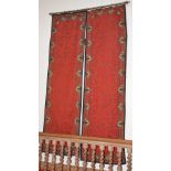 A pair of late 19th century red ground textile wall hangings, of rectangular form with foliate and