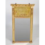 A Regency giltwood pier mirror, of architectural design, the cavetto moulded pediment with ball
