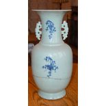A Chinese porcelain celadon ground vase, Qing Dynasty, with blue painted decoration of prunus