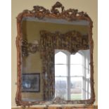 A 19th century gilt wood over mantel mirror, in the Rococo style, the scroll and foliate carved