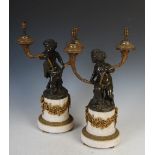 A pair of late 19th century French gilt, patinated bronze and marble candelabra after Clodion,