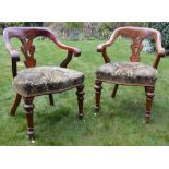 A pair of Victorian mahogany horseshoe back armchairs, the curved top rails above pierced and scroll
