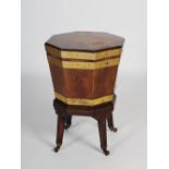 A 19th century brass bound mahogany cellarette, of octagonal form on a stand with four tapering