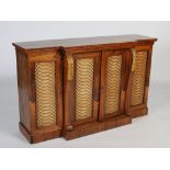 An early 19th century rosewood and giltwood breakfront bookcase, the plain top above a central